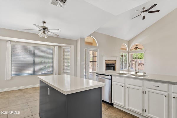 The updated kitchen features a large center island, stainless steel appliances, newer finishes, and an open layout overlooking the family room with backyard access. A perfect design for entertaining and everyday living.