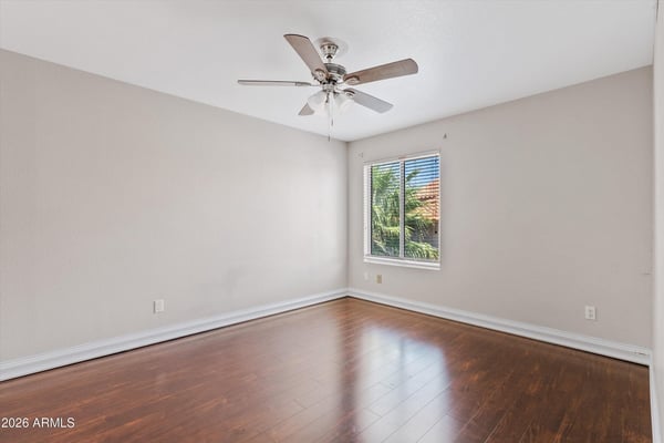 Large windows, wood flooring, and a ceiling fan make this upstairs bedroom bright, comfortable, and move-in ready. An excellent space for guests, family, or a home office.