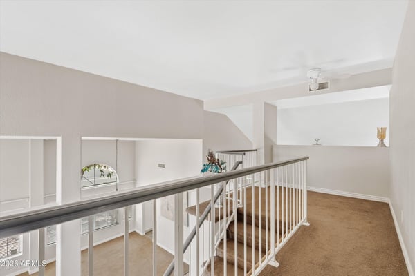 The open loft overlooks the main living area and offers endless possibilities as a family room, media space, playroom, or home office. A valuable bonus feature of this Chandler home.