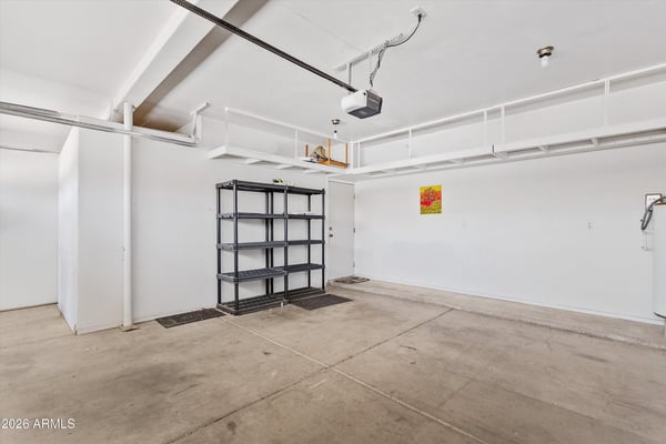 This oversized garage includes built-in overhead storage racks, shelving, and plenty of room for vehicles, hobbies, and equipment. An organized and practical feature that adds value to this Chandler property.