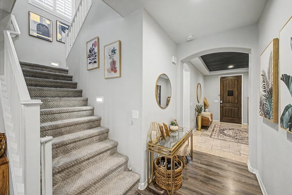 Spacious foyer with upgraded flooring, modern finishes, and a beautiful staircase creates a sophisticated entrance into this thoughtfully designed open-concept home.