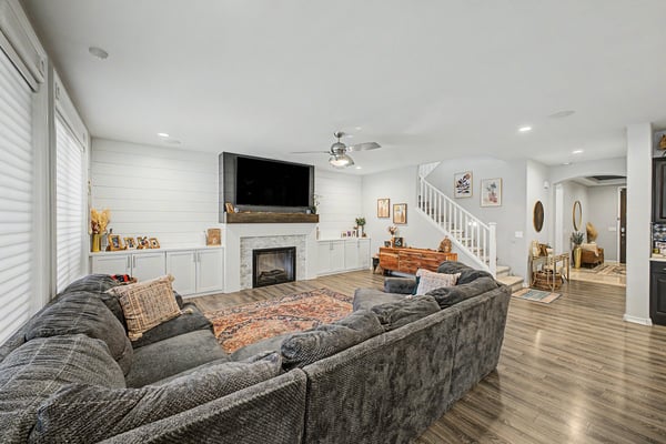 Large great room offers an open layout with custom built-ins, designer fireplace, luxury flooring, and effortless flow into the gourmet kitchen for entertaining.