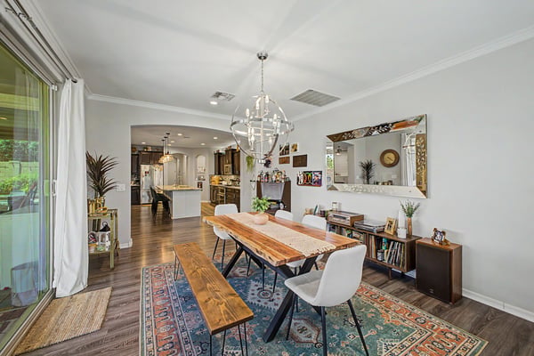 Stylish dining room with abundant natural light, elegant lighting, spacious layout, and convenient connection to the kitchen creates the perfect setting for everyday dining and entertaining.