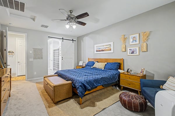 Generously sized primary bedroom features elegant finishes, soft carpeting, and convenient access to the ensuite bathroom, offering comfort and privacy.
