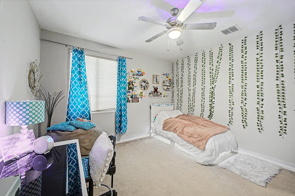 Inviting secondary bedroom offers generous dimensions, decorative finishes, plush carpeting, and abundant natural light, making it perfect for multiple living needs.