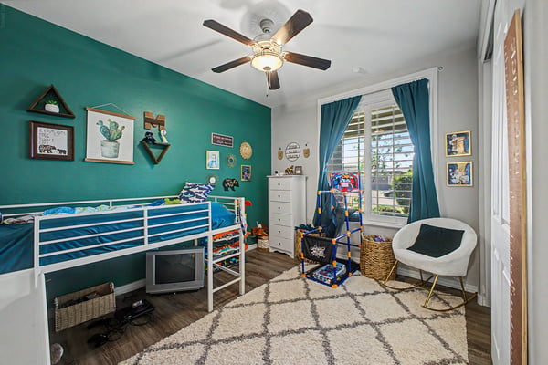 Bright bedroom features upgraded flooring, plantation shutters, contemporary finishes, and a versatile layout ideal for children, guests, or a home office.
