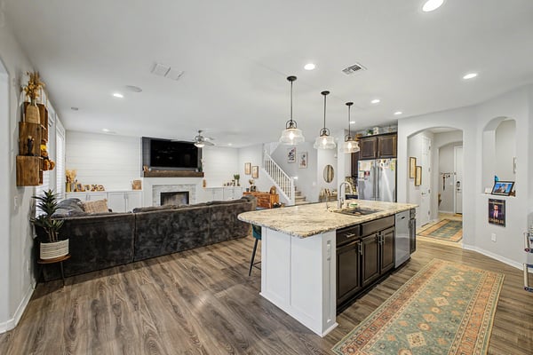 Spacious open-concept design showcases the oversized kitchen island, granite countertops, custom cabinetry, and a welcoming family room ideal for entertaining and everyday living.
