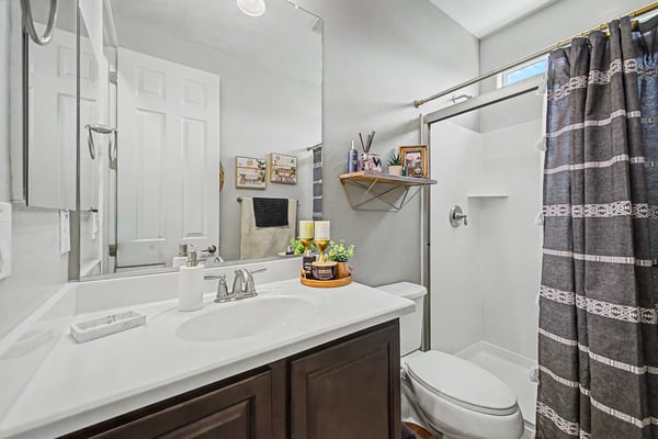 Well-appointed bathroom features a contemporary vanity, updated fixtures, walk-in shower, and stylish finishes, providing comfort and convenience for family and guests.