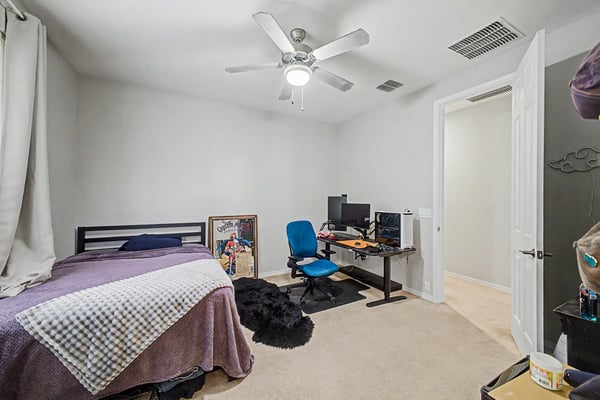 Alternate perspective of the secondary bedroom showcases its open layout, neutral finishes, and comfortable proportions ideal for family members or overnight guests.