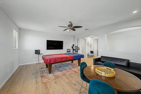 Alternate view of the upstairs bonus room showcases its generous layout, wood-look flooring, and versatile design ideal for gatherings, hobbies, or additional living space.