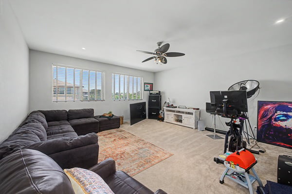 Spacious loft features plush carpeting, oversized windows, and flexible living space that easily accommodates a media room, lounge, or game room.