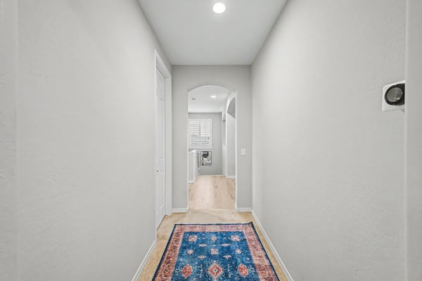 Well-designed upstairs hallway connects the bedrooms and living areas while maintaining an open, bright feel with neutral finishes and quality craftsmanship.