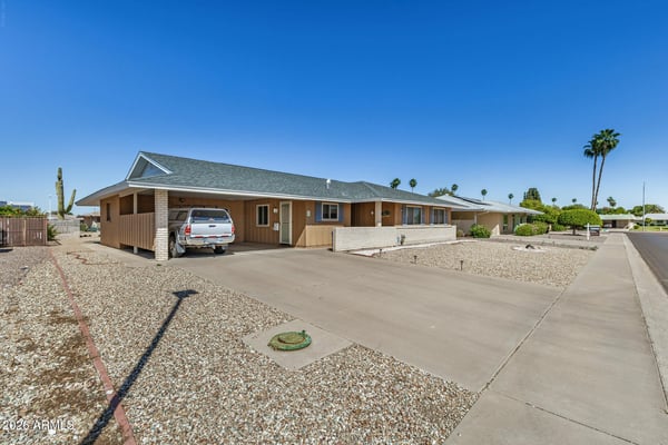Spacious driveway and covered golf cart parking provide convenient parking and easy access while complementing the home's low-maintenance exterior.