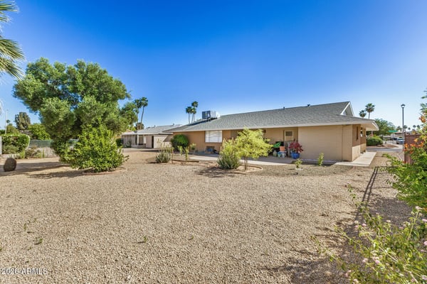 Wide backyard with mature landscaping, desert-friendly design, and generous open space offering endless possibilities for outdoor living and entertaining in Sun City.