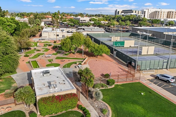 Aerial perspective features miniature golf, tennis courts, landscaped grounds, and nearby recreation amenities. Sun City offers an active outdoor lifestyle with exceptional community facilities.