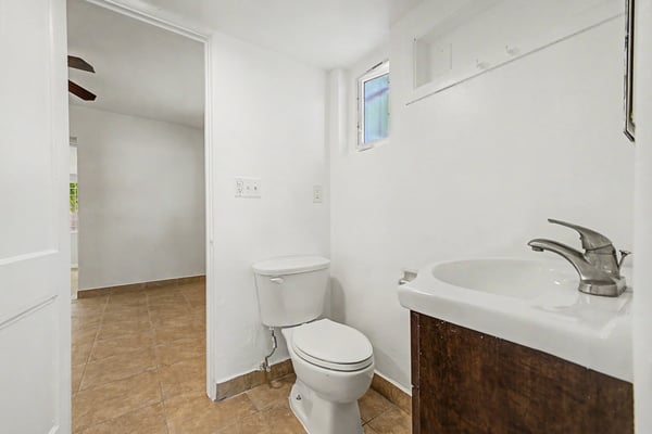 Bathroom vanity area with updated cabinetry, contemporary sink, modern faucet, tile flooring, and natural light. This refreshed bathroom provides both style and functionality within this well-maintained Phoenix property.