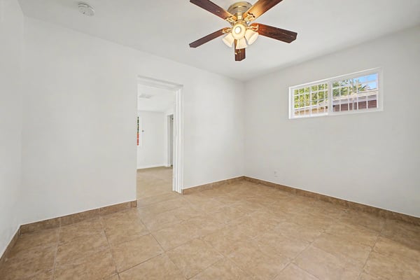 Alternate perspective of the spacious flex room highlighting abundant natural light, durable flooring, and versatile layout. This adaptable space easily accommodates a variety of lifestyle needs.