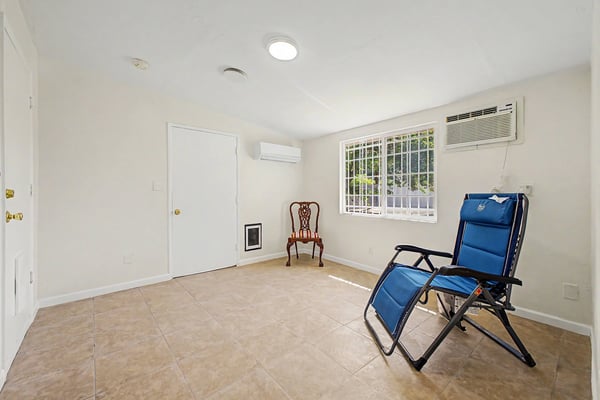 Alternate perspective of the bright flex room featuring tile flooring, natural light, mini-split air conditioning, and an adaptable floor plan. A versatile space ready to fit a variety of lifestyle needs.