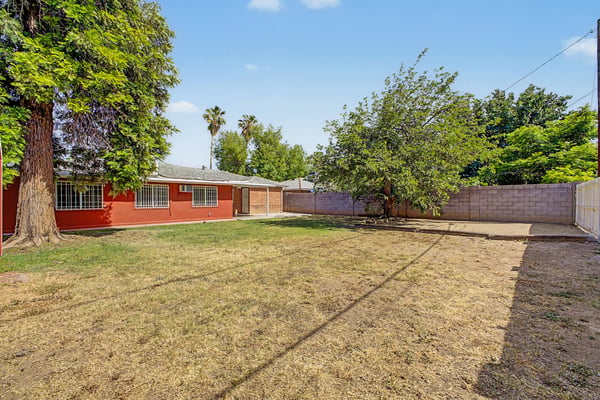 Expansive backyard with mature trees, open lawn, and plenty of room for outdoor entertaining, play, pets, or gardening. This flexible outdoor space enhances the lifestyle offered by this Phoenix property.