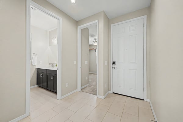 Bright foyer with tile flooring, neutral finishes, and a functional layout that leads effortlessly into the home's open-concept living spaces. A clean and inviting introduction to the home.