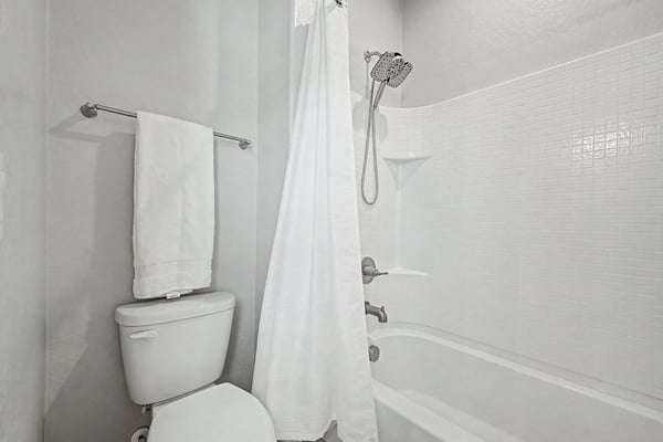 Clean and inviting full bathroom featuring a tub/shower combination, updated fixtures, and bright finishes. A functional space designed to comfortably serve family members and guests.
