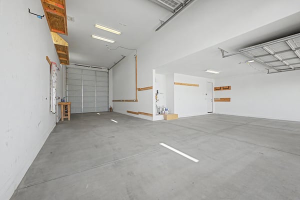 Oversized RV garage offering exceptional ceiling height, durable concrete flooring, built-in storage, and abundant room for recreational vehicles, multiple cars, or workshop space. A rare feature in this Wittman property.