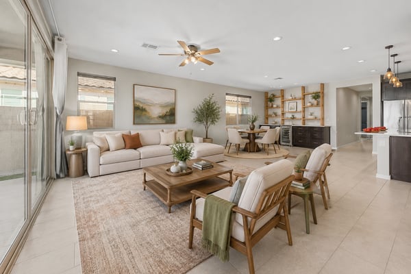 Virtually Staged Spacious great room with recessed lighting, ceiling fan, and oversized sliding glass doors that connect indoor and outdoor living. The custom built-in entertainment area adds both style and functionality.
