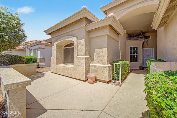 A peaceful courtyard entry leads guests to the front door while providing a private outdoor sitting area surrounded by low-maintenance landscaping. This welcoming entrance adds charm and convenience to everyday living.