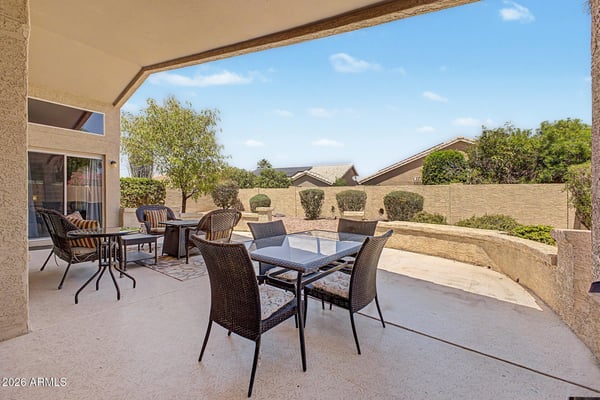 Entertain with ease beneath the large covered patio featuring multiple seating areas and attractive outdoor living space. The private backyard offers a wonderful extension of the home's interior.
