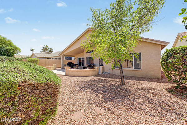 The beautifully maintained backyard offers mature trees, low-maintenance landscaping, and plenty of open space for relaxing or entertaining while enjoying the Arizona sunshine.