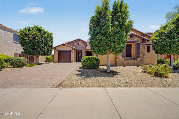 The attractive exterior showcases stone accents, low-maintenance desert landscaping, a paver driveway, and a 3-car garage. Exceptional curb appeal complements this beautifully maintained Goodyear residence.