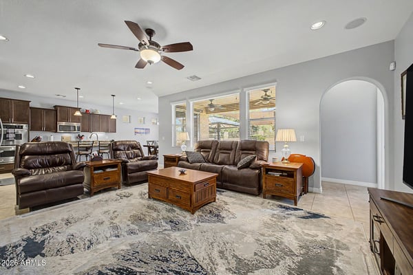 Gather in this spacious great room featuring oversized windows, recessed lighting, ceiling fan, and an open layout flowing effortlessly into the kitchen. Designed for entertaining and comfortable everyday living.