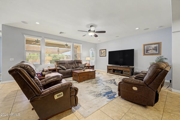 The welcoming great room offers generous seating space, abundant natural light, and an open-concept design that connects beautifully with the kitchen and dining areas, creating an inviting atmosphere throughout the home.