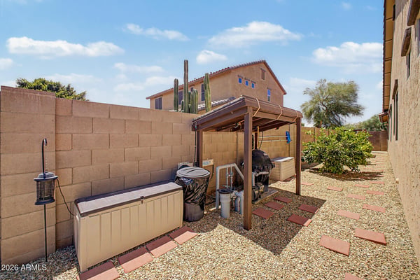 Gravel landscaping, organized pool equipment, and stepping-stone pathways create a clean, efficient outdoor area designed for simple maintenance and year-round enjoyment in Goodyear.