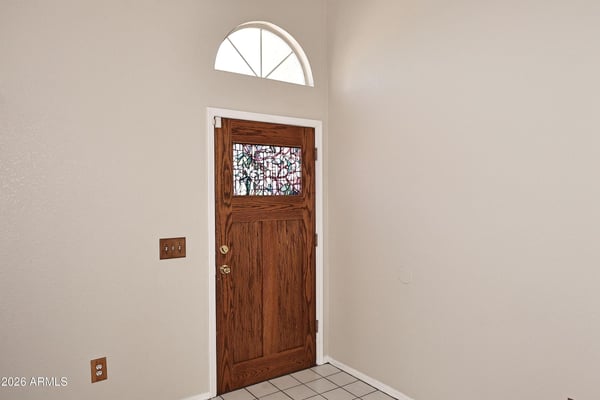 Bright foyer welcomes guests with vaulted ceilings, natural light, and a spacious layout that creates an open and inviting first impression.
