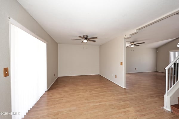 Bright family room offers soaring ceilings, updated flooring, generous living space, and a flexible layout designed for comfortable everyday living.