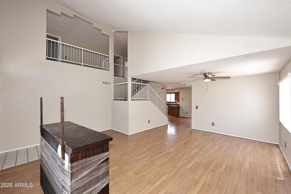 Expansive living and dining area boasts soaring ceilings, updated flooring, and an open layout designed for entertaining, relaxing, and flexible furniture arrangements.