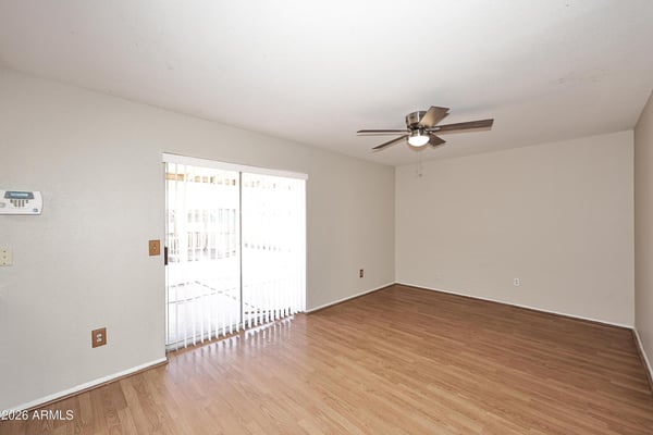 Spacious family room offers updated flooring, ceiling fan, and sliding door access to the backyard, creating an ideal indoor-outdoor living experience.