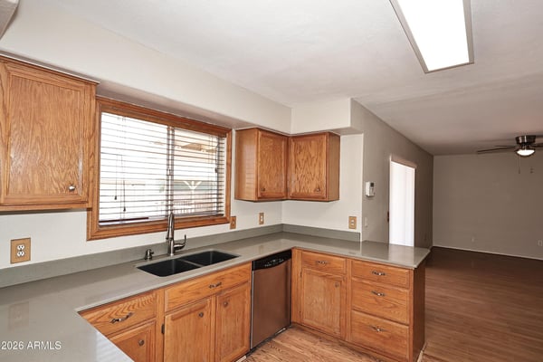 Kitchen showcases abundant cabinet storage, generous work surfaces, breakfast bar seating, and an open floor plan perfect for entertaining and daily living.
