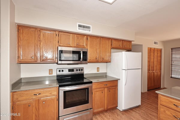 Well-equipped kitchen includes stainless steel appliances, plentiful cabinetry, expansive countertops, and a practical layout that supports effortless meal preparation.