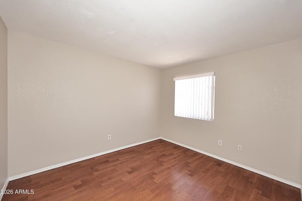 Third bedroom offers updated flooring, natural light, and versatile space that works equally well as a bedroom, office, or creative workspace.