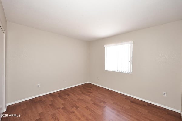 Comfortable fourth bedroom features updated flooring, natural light, and versatile space ideal for guests, family members, or remote work.