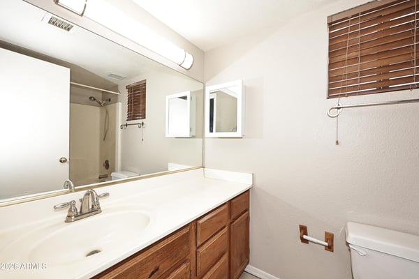 Hall bathroom features a generous vanity, oversized mirror, and practical storage, offering convenience for residents and visitors alike.