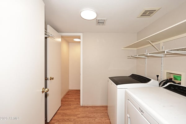 Functional laundry room includes washer and dryer, built-in shelving, and convenient storage to simplify everyday household tasks.