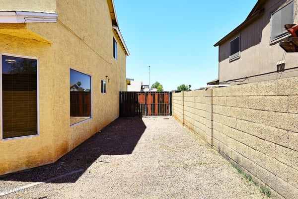 Gated side yard provides convenient RV parking or extra storage space, offering added functionality and flexibility for renters seeking room for larger vehicles in Phoenix.