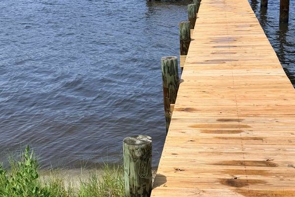 Inviting waterfront property featuring a spacious dock, perfect for boating and enjoying scenic water views.