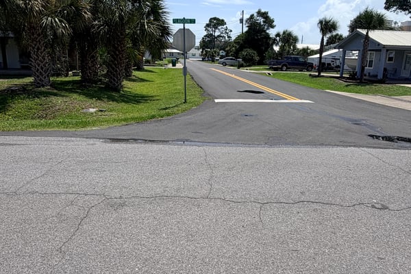 Vacant lot in a welcoming neighborhood, ready for your dream home near scenic palm trees.