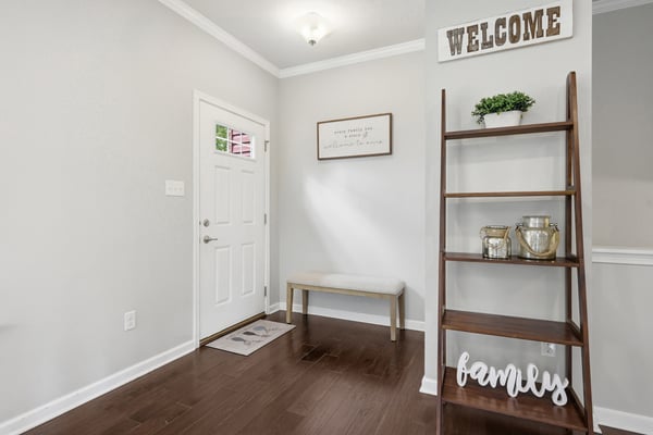 Bright entryway featuring a modern design with warm wooden accents and inviting decor.