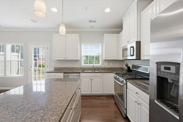 Bright and spacious kitchen featuring modern appliances, ample storage, and a large island perfect for meals.