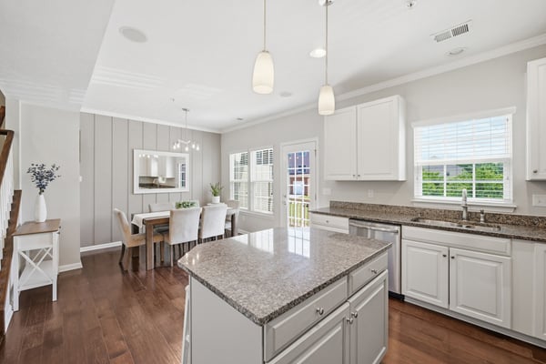 Bright, open kitchen features modern appliances, ample counter space, and a cozy dining area for gatherings.